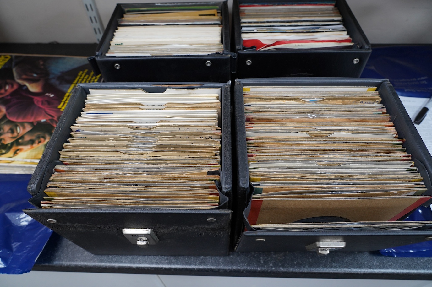 Four 7” singles carry cases containing a large collection of mainly Eddie Cochran 7” singles, a few in picture sleeves, on labels, including; London, Rock Star, etc. Condition - fair